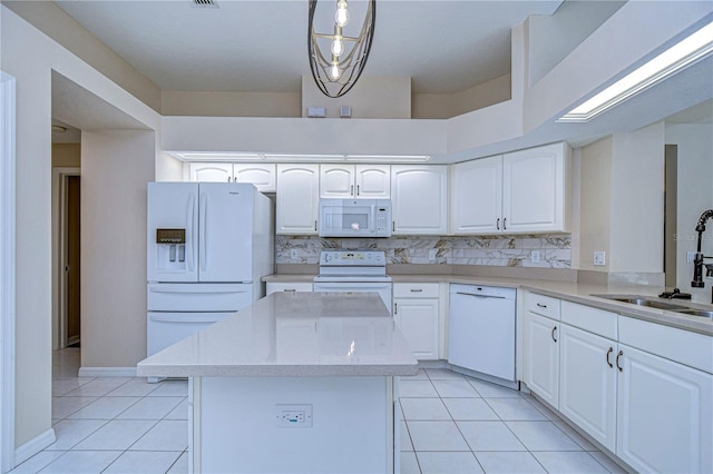 kitchen with white cabinets, light tile patterned floors, sink, pendant lighting, and white appliances