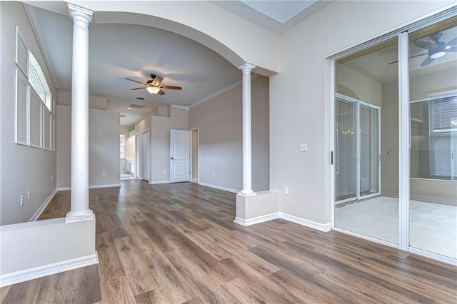 unfurnished living room featuring hardwood / wood-style floors, ceiling fan, ornamental molding, and decorative columns