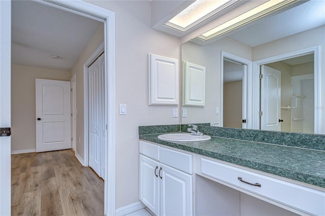 bathroom featuring hardwood / wood-style flooring and vanity