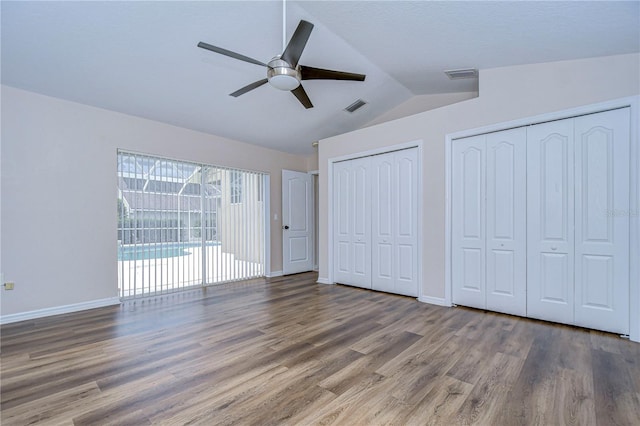 unfurnished bedroom with lofted ceiling, ceiling fan, and wood-type flooring