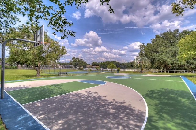 view of basketball court with a yard