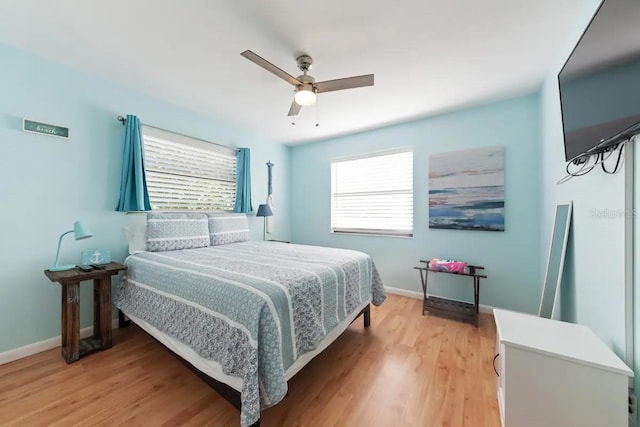 bedroom with ceiling fan and light hardwood / wood-style flooring