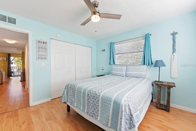 bedroom with a closet, hardwood / wood-style flooring, and ceiling fan