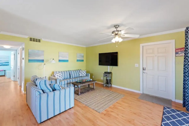 living room featuring wood-type flooring, ceiling fan, and crown molding