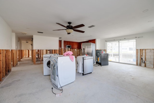 living room with ceiling fan, wooden walls, and independent washer and dryer