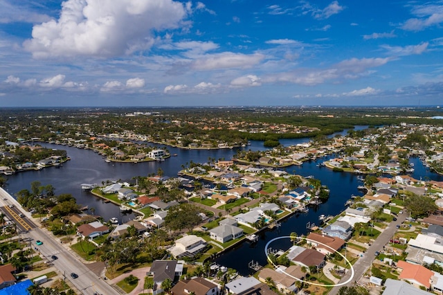 birds eye view of property featuring a water view and a residential view