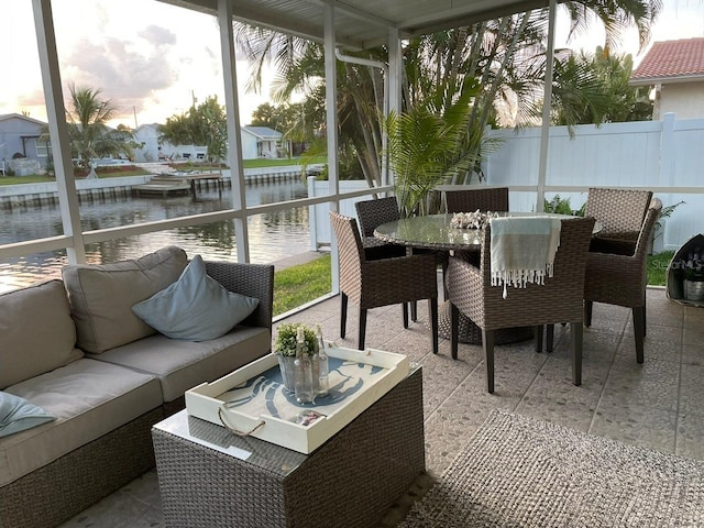 sunroom / solarium with a water view