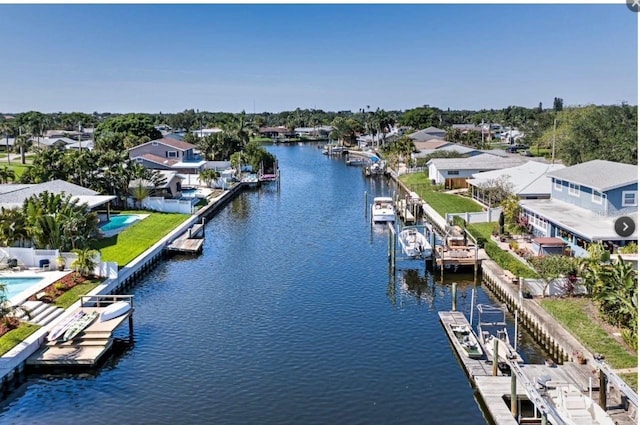 drone / aerial view featuring a residential view and a water view