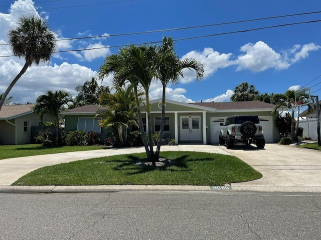 single story home featuring an attached garage, driveway, and a front yard