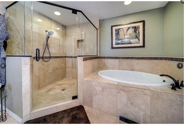 bathroom with a stall shower, tile patterned flooring, a bath, and recessed lighting