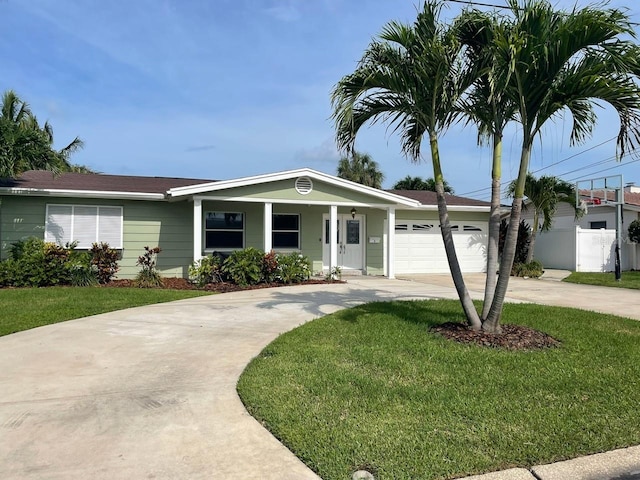 single story home with a front lawn, concrete driveway, fence, and an attached garage