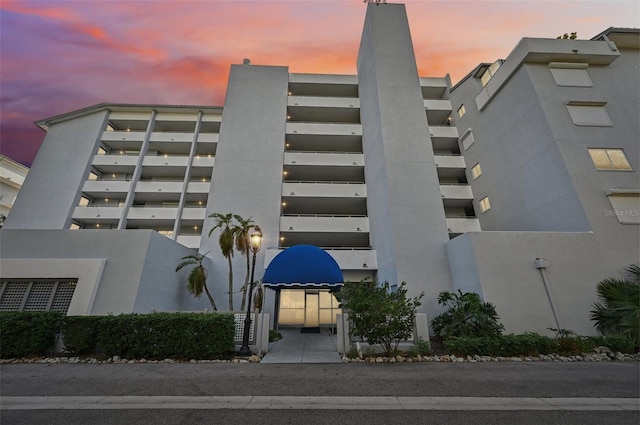 view of outdoor building at dusk