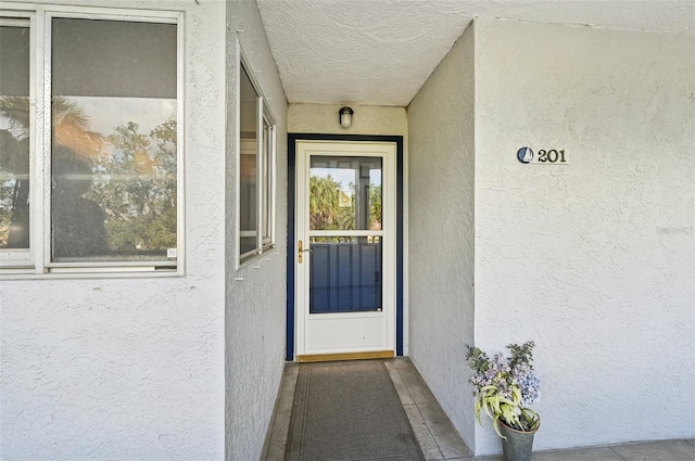 1050 Riverside Dr Unit A201, Palmetto, FL 34221 - view of exterior entry featuring stucco siding
