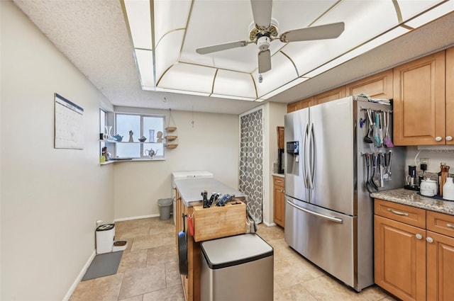 1050 Riverside Dr Unit A201, Palmetto, FL 34221 - kitchen featuring stainless steel refrigerator with ice dispenser, a ceiling fan, baseboards, and brown cabinets