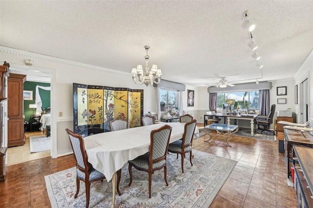 dining room featuring crown molding, dark tile patterned floors, ceiling fan with notable chandelier, and a textured ceiling