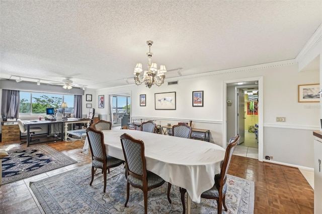 dining area with tile patterned floors, ceiling fan with notable chandelier, ornamental molding, and a textured ceiling