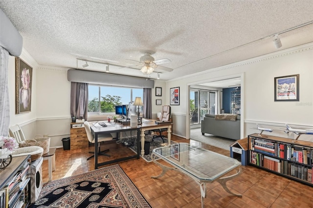 1050 Riverside Dr Unit A201, Palmetto, FL 34221 - home office featuring rail lighting, plenty of natural light, a ceiling fan, a textured ceiling, and wainscoting