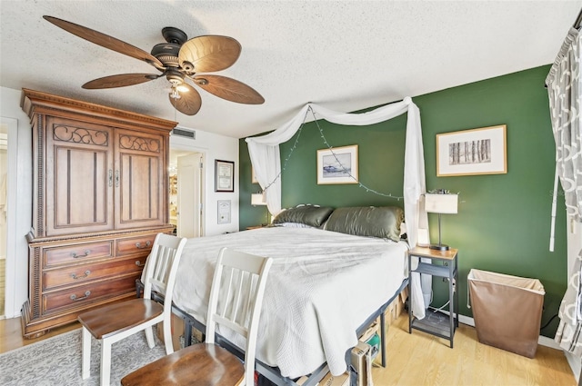 1050 Riverside Dr Unit A201, Palmetto, FL 34221 - bedroom with a textured ceiling, light wood-style floors, and ceiling fan