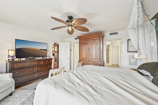 1050 Riverside Dr Unit A201, Palmetto, FL 34221 - bedroom with a textured ceiling, a ceiling fan, and wood finished floors