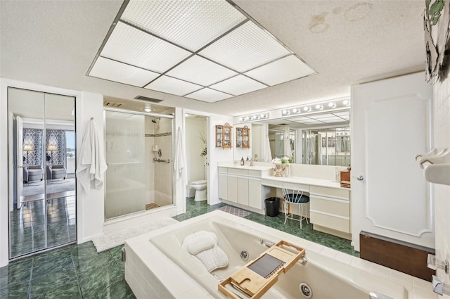 full bathroom featuring vanity, tile patterned flooring, toilet, a textured ceiling, and shower with separate bathtub