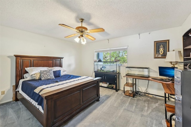 1050 Riverside Dr Unit A201, Palmetto, FL 34221 - bedroom featuring a desk, light carpet, a textured ceiling, a ceiling fan, and baseboards