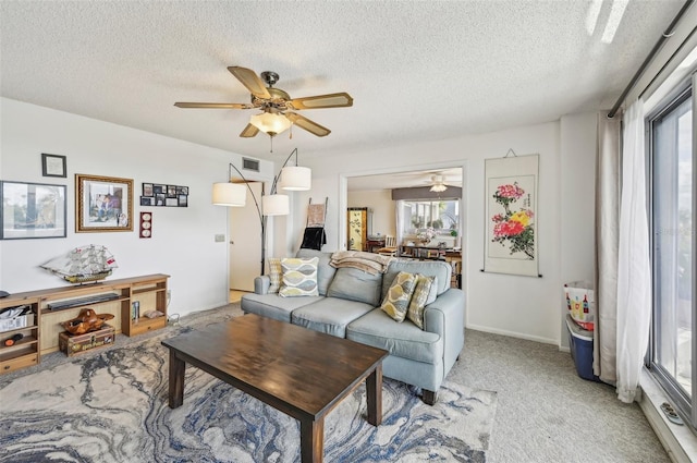 1050 Riverside Dr Unit A201, Palmetto, FL 34221 - living room featuring ceiling fan, a textured ceiling, and light carpet