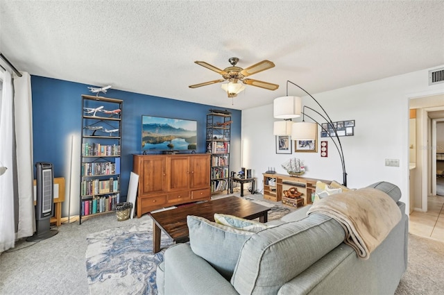 1050 Riverside Dr Unit A201, Palmetto, FL 34221 - living area with a ceiling fan, carpet, and a textured ceiling