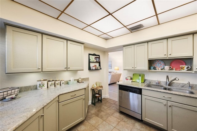 kitchen with gray cabinets, stainless steel dishwasher, sink, and light stone countertops