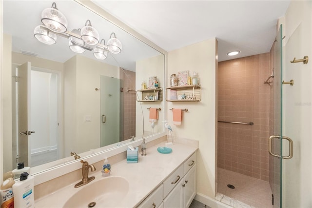 bathroom featuring vanity and a shower with door