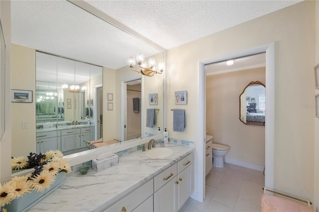 bathroom featuring vanity, tile patterned flooring, a textured ceiling, and toilet