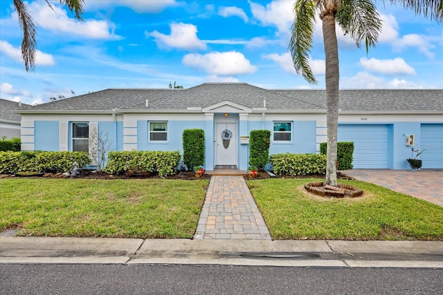 ranch-style house with a front lawn and a garage