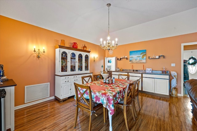 dining room featuring hardwood / wood-style flooring and a chandelier