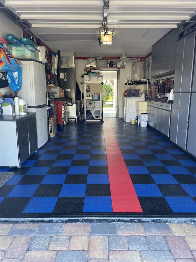 garage with a garage door opener, washing machine and dryer, electric water heater, and refrigerator