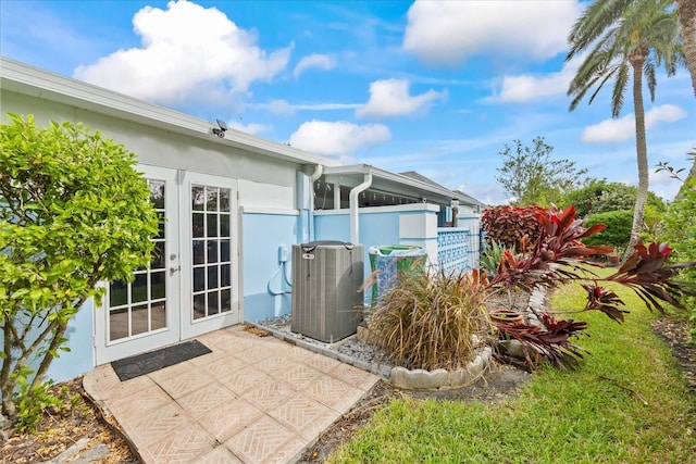 exterior space with french doors, a patio area, and central air condition unit