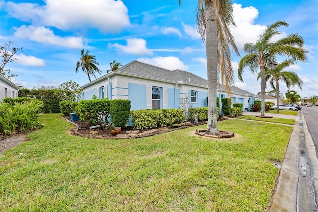 view of side of home featuring a lawn