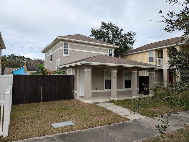 view of front of house with a porch and a front yard