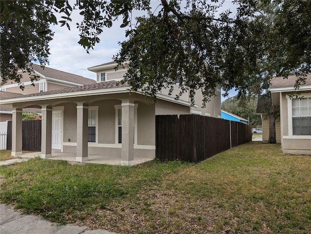 view of side of property featuring a yard