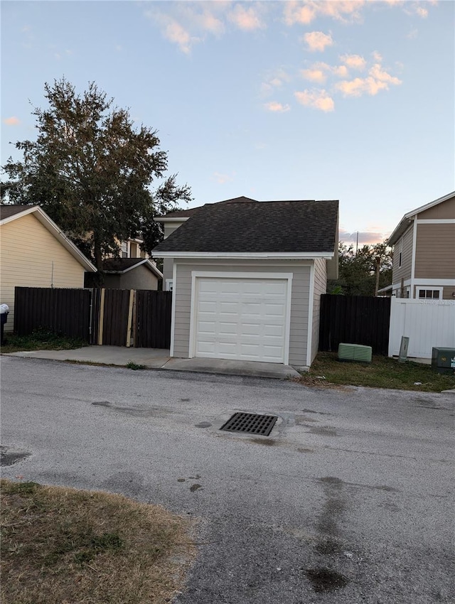 exterior space featuring a garage and an outdoor structure