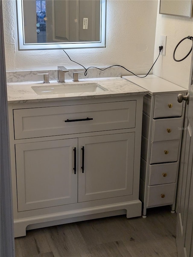 bathroom featuring hardwood / wood-style floors and vanity