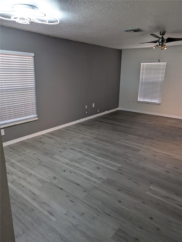 unfurnished room with ceiling fan, hardwood / wood-style floors, and a textured ceiling