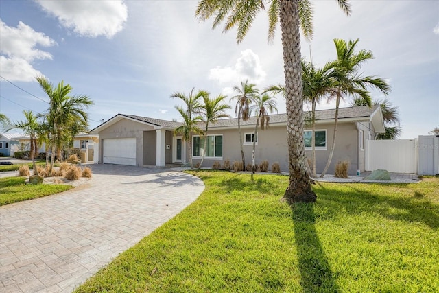 ranch-style home with a garage and a front yard