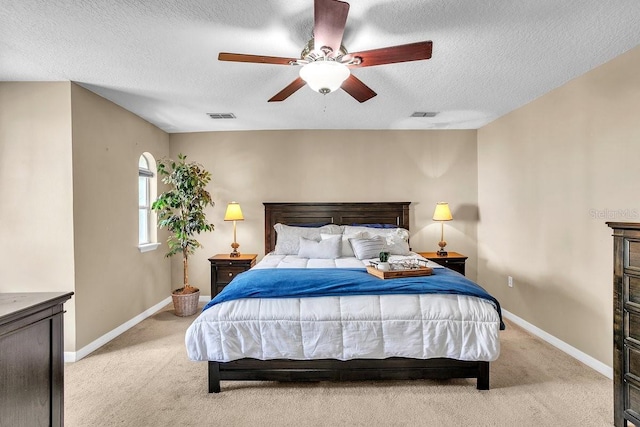 bedroom with visible vents, baseboards, and light colored carpet