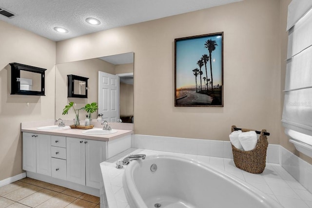 full bathroom with tile patterned floors, visible vents, a garden tub, and a sink