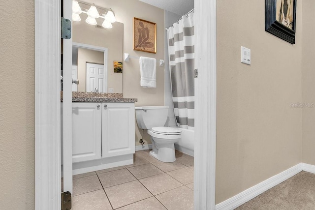 full bath featuring vanity, baseboards, tile patterned flooring, shower / bath combo with shower curtain, and toilet