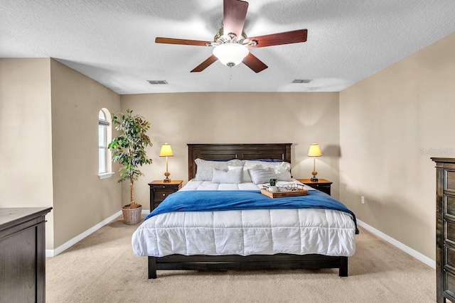 411 S Fremont Ave Unit B, Tampa, FL 33606 - bedroom with light carpet, baseboards, a textured ceiling, and a ceiling fan