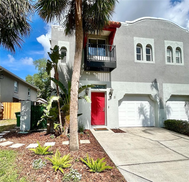 411 S Fremont Ave Unit B, Tampa, FL 33606 - view of front of home with stucco siding, an attached garage, and a balcony