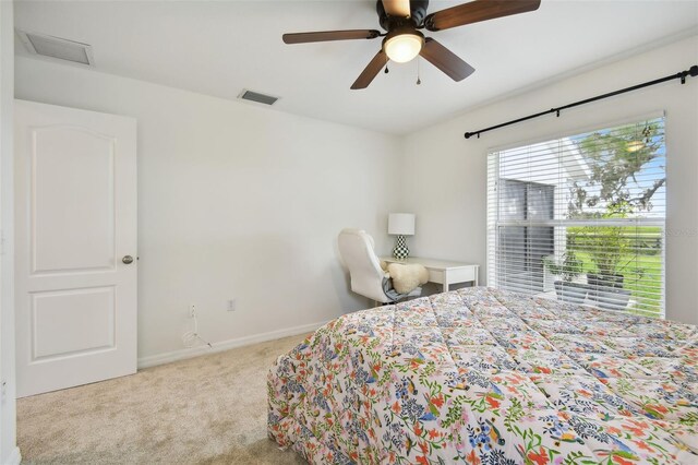 bedroom with light carpet and ceiling fan