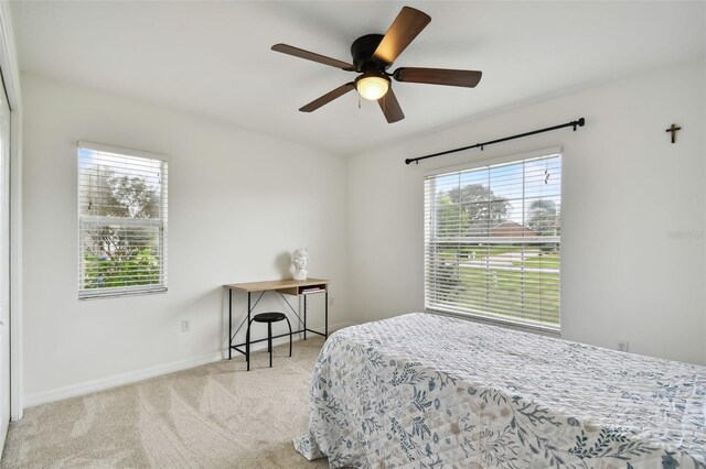 bedroom with light carpet and ceiling fan