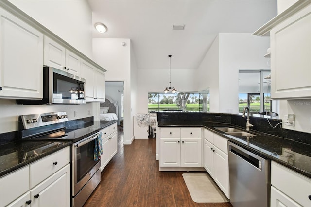 kitchen featuring pendant lighting, sink, white cabinets, and appliances with stainless steel finishes