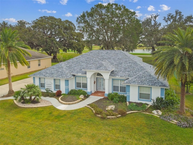 single story home featuring a front lawn